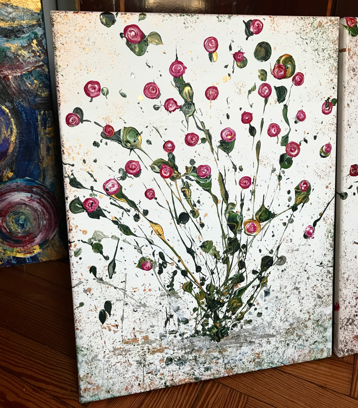 Pink bunch of roses, explosive and slightly abstract on a dappled silver background.